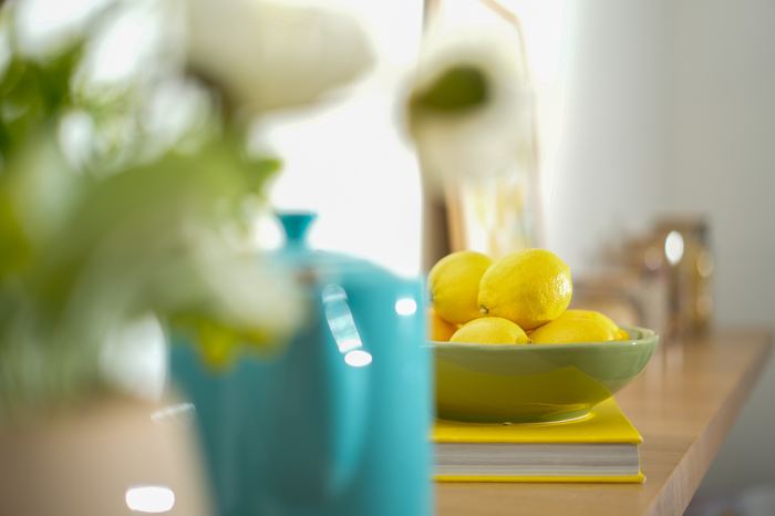 Bowl of lemons styling detail on a stack of books