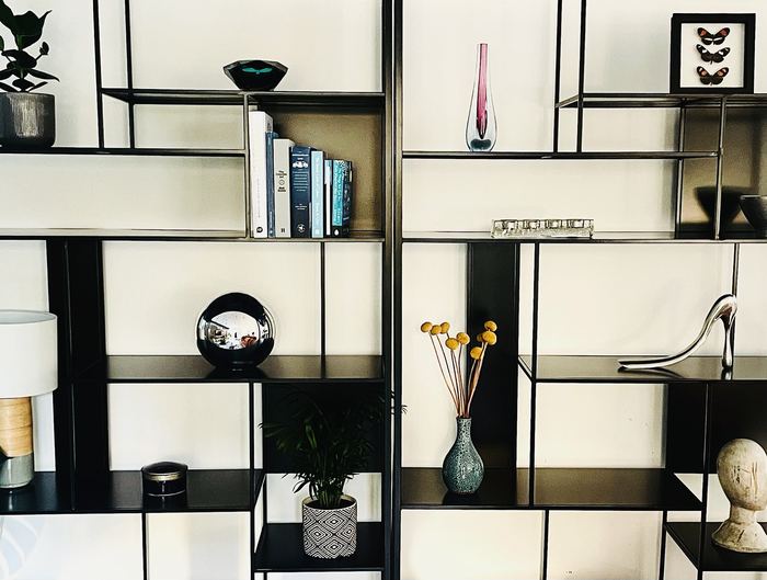 Styled shelving unit detail with books, vases and decorative objects