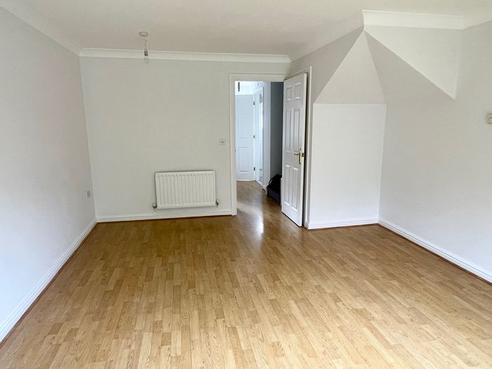 Empty bedroom before home staging, wood laminate flooring