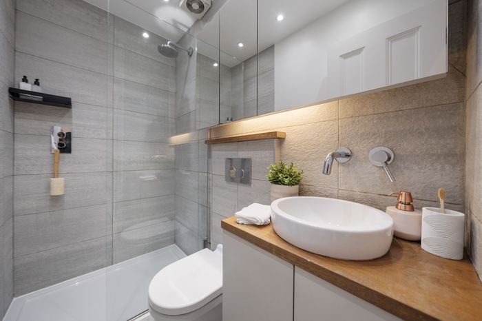 Bathroom styled with a walk-in shower, vessel sink and wood countertop