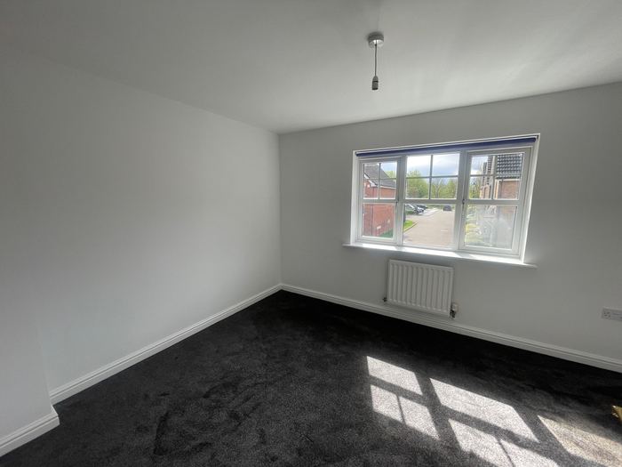 Empty bedroom before home staging, dark carpet