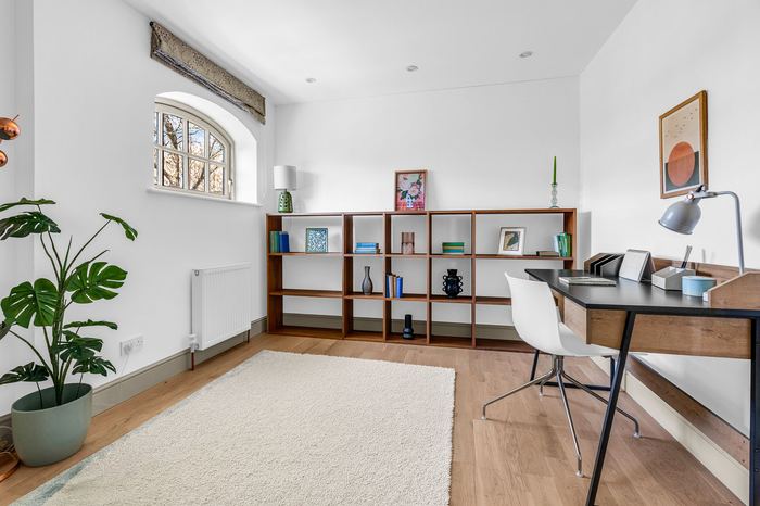 Home office staged with a bookshelf and desk, home organising service